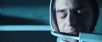Movie still from “Moon” (2009), directed by Duncan Jones – A person wearing a space helmet; Close Up shot, Overhead angle