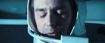 Movie still from “Moon” (2009), directed by Duncan Jones – A person wearing a space helmet; Close Up shot, Overhead angle
