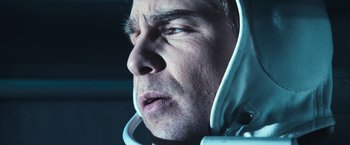 Movie still from “Moon” (2009), directed by Duncan Jones – A person wearing a space suit; Close Up shot, Low angle