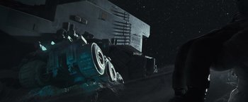 Movie still from “Moon” (2009), directed by Duncan Jones – An image of a truck on the side of the road at night; Wide shot, Low angle