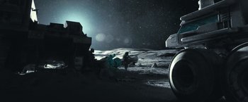 Movie still from “Moon” (2009), directed by Duncan Jones – A person standing on the side of the moon at night; Extreme Wide shot, Low angle