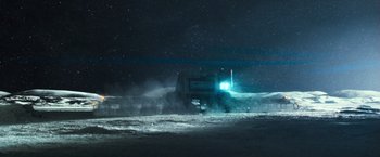 Movie still from “Moon” (2009), directed by Duncan Jones – A truck driving down a road at night with fog; Extreme Wide shot, Low angle