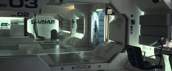 Movie still from “Moon” (2009), directed by Duncan Jones – A room that has a window in it; Wide shot, High angle