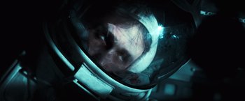 Movie still from “Moon” (2009), directed by Duncan Jones – A man in a space helmet looking at the camera; Close Up shot, Overhead angle