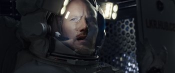 Movie still from “Moonfall” (2022), directed by Roland Emmerich – An image of a man in a space suit; Close Up shot, Over the shoulder angle