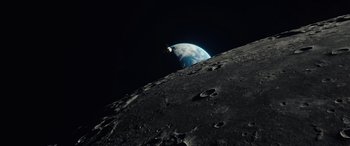 Movie still from “Moonfall” (2022), directed by Roland Emmerich – A view of the earth from the side of the moon at night; Extreme Wide shot, High angle