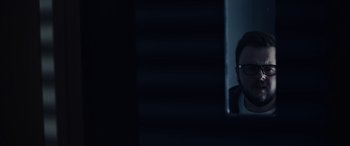 Movie still from “Moonfall” (2022), directed by Roland Emmerich – A man sitting in front of a computer monitor; Close Up shot, Low angle