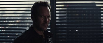 Movie still from “Moonfall” (2022), directed by Roland Emmerich – A person wearing a black shirt; Close Up shot, Over the shoulder angle