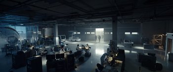 Movie still from “Moonfall” (2022), directed by Roland Emmerich – A group of people sitting at tables in a room; Extreme Wide shot, High angle