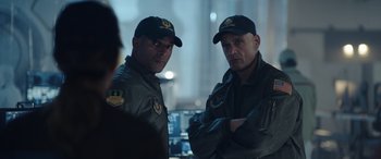 Movie still from “Moonfall” (2022), directed by Roland Emmerich – A couple of men standing next to each other; Medium shot, Over the shoulder angle