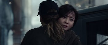 Movie still from “Moonfall” (2022), directed by Roland Emmerich – A woman is hugging another woman with a hat on; Close Up shot, Over the shoulder angle
