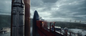 Movie still from “Moonfall” (2022), directed by Roland Emmerich – A person standing on top of a train; Extreme Wide shot, Low angle