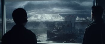 Movie still from “Moonfall” (2022), directed by Roland Emmerich – A view of a large body of water with a mountain in the background; Extreme Wide shot, Over the shoulder angle