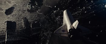 Movie still from “Moonfall” (2022), directed by Roland Emmerich – An image of a space shuttle on the moon; Extreme Wide shot, Overhead angle