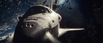 Movie still from “Moonfall” (2022), directed by Roland Emmerich – An image of a space shuttle in the middle of the night; Extreme Wide shot, Overhead angle