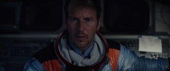 Movie still from “Moonfall” (2022), directed by Roland Emmerich – A person wearing a space suit; Close Up shot, Low angle