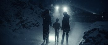 Movie still from “Moonfall” (2022), directed by Roland Emmerich – A group of people standing in the snow at night; Wide shot, Low angle