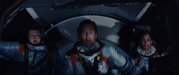 Movie still from “Moonfall” (2022), directed by Roland Emmerich – A man wearing a space suit in a space station; Medium shot, Overhead angle
