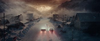 Movie still from “Moonfall” (2022), directed by Roland Emmerich – Two cars driving down a street in the middle of the night; Extreme Wide shot, High angle