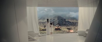 Movie still from “Moonfall” (2022), directed by Roland Emmerich – A woman and a child standing in front of an image; Extreme Wide shot, High angle