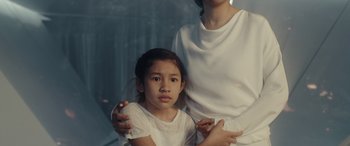 Movie still from “Moonfall” (2022), directed by Roland Emmerich – A woman and a young girl in white shirts; Close Up shot, Over the shoulder angle