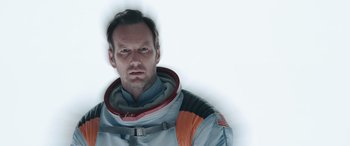 Movie still from “Moonfall” (2022), directed by Roland Emmerich – A man in a space suit is looking at the camera; Close Up shot, Overhead angle