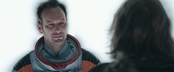 Movie still from “Moonfall” (2022), directed by Roland Emmerich – A man in a space suit is talking to a woman; Close Up shot, Over the shoulder angle