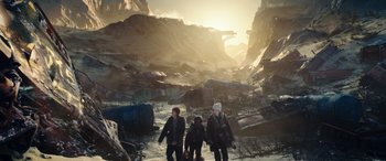 Movie still from “Moonfall” (2022), directed by Roland Emmerich – A group of people standing on top of a mountain; Extreme Wide shot, High angle