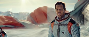 Movie still from “Moonfall” (2022), directed by Roland Emmerich – A man in a spacesuit standing in front of a hot air balloon; Close Up shot, Low angle