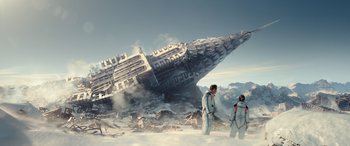 Movie still from “Moonfall” (2022), directed by Roland Emmerich – Two people standing in front of an airplane wreckage in the snow; Extreme Wide shot, Low angle