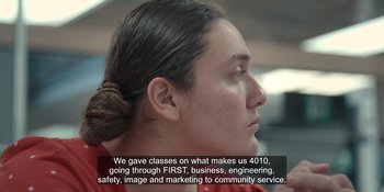 Movie still from “More Than Robots” (2022), directed by Gillian Jacobs – A woman that is looking into the distance; Extreme Close Up shot, Over the shoulder angle