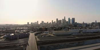 Movie still from “More Than Robots” (2022), directed by Gillian Jacobs – A view of a city skyline from a distance; Extreme Wide shot, High angle