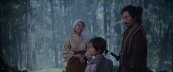 Movie still from “Mortal Kombat” (2021), directed by Simon McQuoid – A woman and a child dressed in traditional japanese clothing; Medium shot, Over the shoulder angle