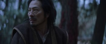 Movie still from “Mortal Kombat” (2021), directed by Simon McQuoid – A person with long hair; Close Up shot, Low angle