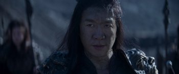 Movie still from “Mortal Kombat” (2021), directed by Simon McQuoid – A person with long black hair; Close Up shot, High angle