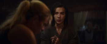 Movie still from “Mortal Kombat” (2021), directed by Simon McQuoid – A young man holding something in front of a mirror; Close Up shot, Over the shoulder angle