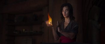 Movie still from “Mortal Kombat” (2021), directed by Simon McQuoid – A man is holding a fire in his hands; Medium shot, Over the shoulder angle
