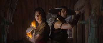 Movie still from “Mortal Kombat” (2021), directed by Simon McQuoid – Two men are standing in front of a wall; Medium shot, Low angle