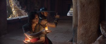 Movie still from “Mortal Kombat” (2021), directed by Simon McQuoid – A man and a woman are holding a fire; Medium shot, Low angle