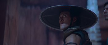 Movie still from “Mortal Kombat” (2021), directed by Simon McQuoid – A man with a hat is looking up at the sky; Close Up shot, Low angle