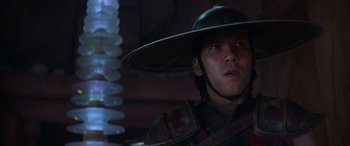 Movie still from “Mortal Kombat” (2021), directed by Simon McQuoid – A man wearing a hat with a sword in his hand; Close Up shot, Low angle