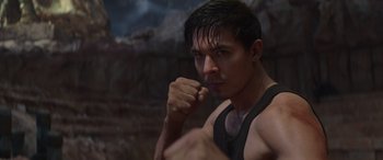 Movie still from “Mortal Kombat” (2021), directed by Simon McQuoid – A person wearing a tank top; Close Up shot, Low angle