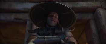 Movie still from “Mortal Kombat” (2021), directed by Simon McQuoid – A man wearing a hat and a leather armor; Close Up shot, Low angle