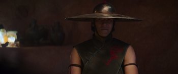 Movie still from “Mortal Kombat” (2021), directed by Simon McQuoid – A person wearing a hat and a leather vest; Close Up shot, Low angle
