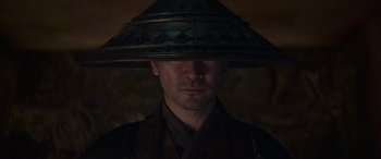 Movie still from “Mortal Kombat” (2021), directed by Simon McQuoid – A man with a hat on his head; Close Up shot, Low angle