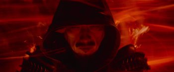 Movie still from “Mortal Kombat” (2021), directed by Simon McQuoid – A man wearing a black hooded jacket and a black hat; Extreme Close Up shot, High angle