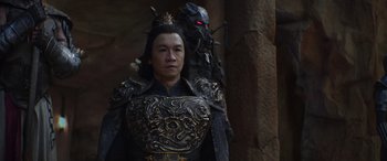 Movie still from “Mortal Kombat” (2021), directed by Simon McQuoid – A man in a black and gold outfit standing next to another man in a black and gold outfit; Medium shot, Low angle