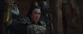 Movie still from “Mortal Kombat” (2021), directed by Simon McQuoid – A man in a costume next to an evil creature; Close Up shot, Over the shoulder angle