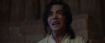 Movie still from “Mortal Kombat” (2021), directed by Simon McQuoid – A person with blood on his face; Close Up shot, Low angle