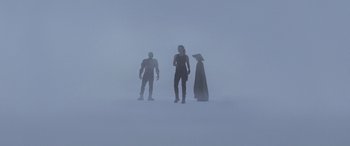 Movie still from “Mortal Kombat” (2021), directed by Simon McQuoid – A group of people standing in the middle of a foggy area; Wide shot, Low angle